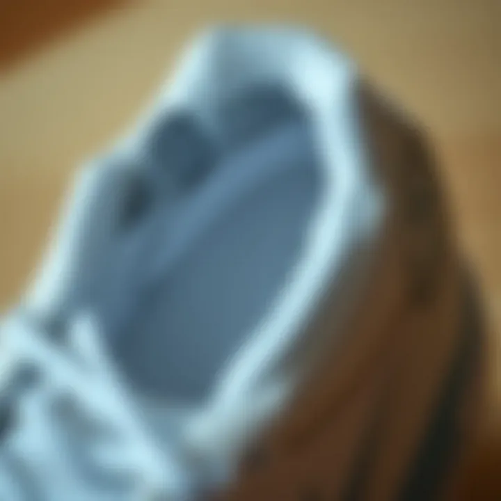 Close-up of the material and cushioning of white volleyball shoes.