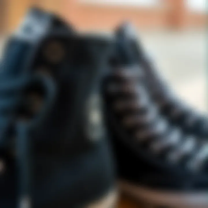 Close-up of black high-top Converse sneakers showcasing their unique design features.