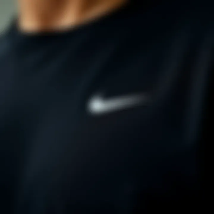 Close-up view of the fabric and technical features of black Nike t-shirt.